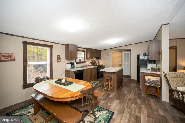a living room with furniture a dining table and kitchen view