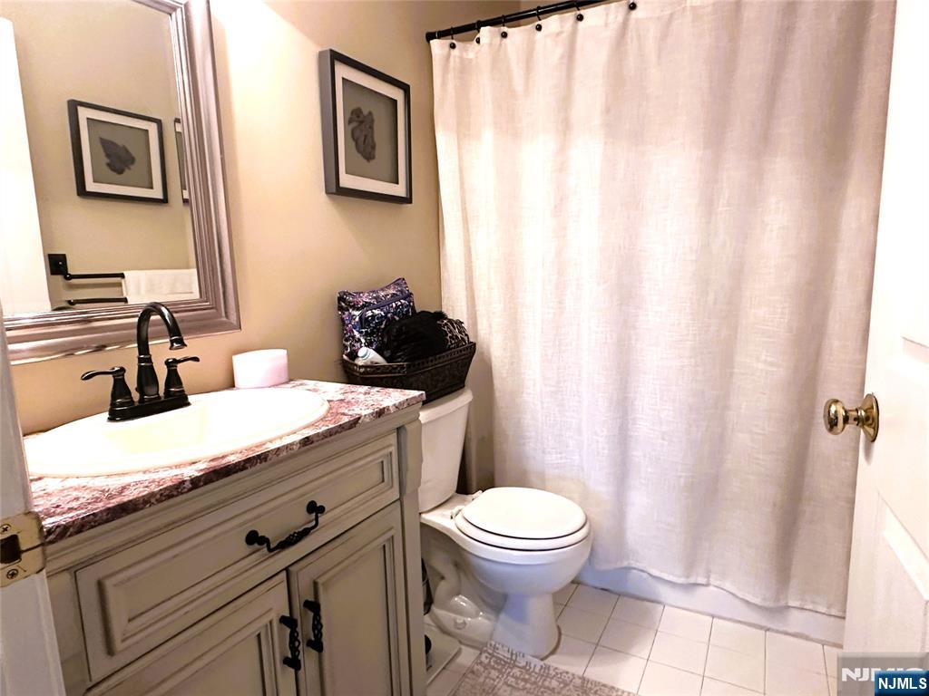 39 Union Street, Unit 105 Hackensack, NJ 07601 - Photo 11 of 22 a bathroom with a granite countertop sink toilet and shower