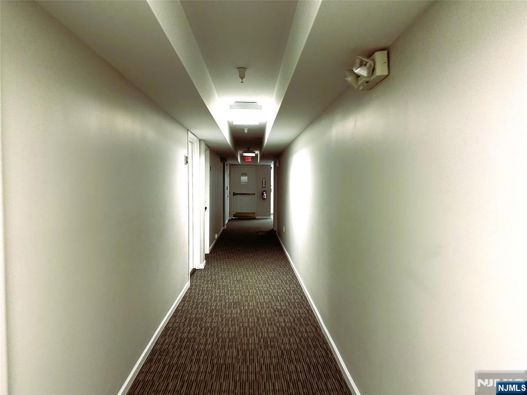 39 Union Street, Unit 105 Hackensack, NJ 07601 - Photo 3 of 22 a view of a hallway with wooden floor