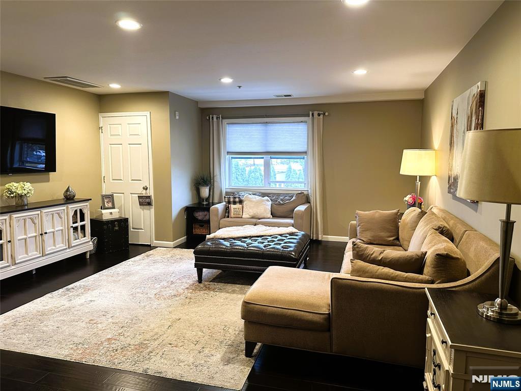 39 Union Street, Unit 105 Hackensack, NJ 07601 - Photo 4 of 22 a living room with furniture and a flat screen tv