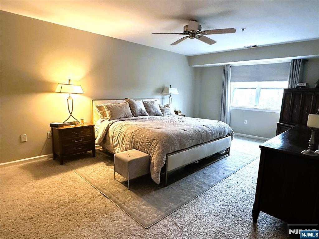 39 Union Street, Unit 105 Hackensack, NJ 07601 - Photo 9 of 22 a bedroom with a bed and a desk