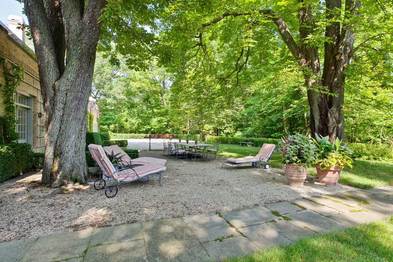 111 Moffett Road Lake Bluff, IL 60044 - Photo 45 of 51 a view of a backyard with lawn chairs and a large tree