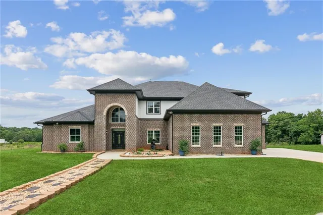 a front view of a house with a garden