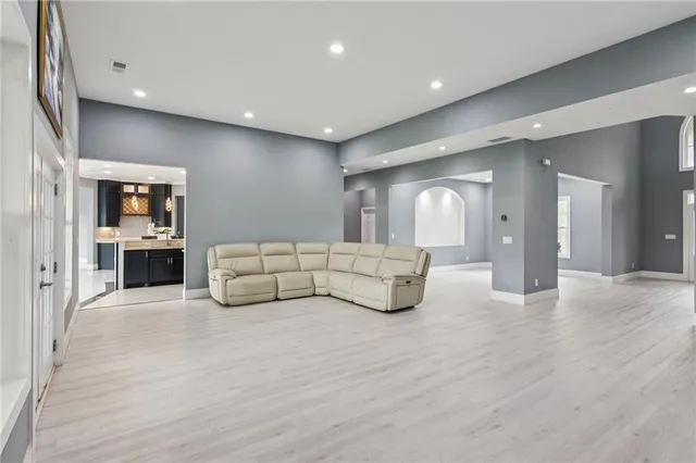 a living room with furniture and a wooden floor