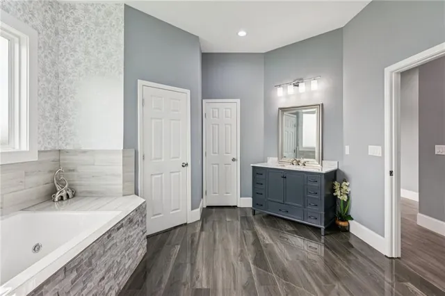 a bedroom with a large bed and a potted plant