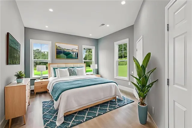 a spacious bedroom with a bed and a window