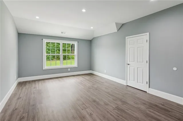a view of a big house with a big yard and large trees