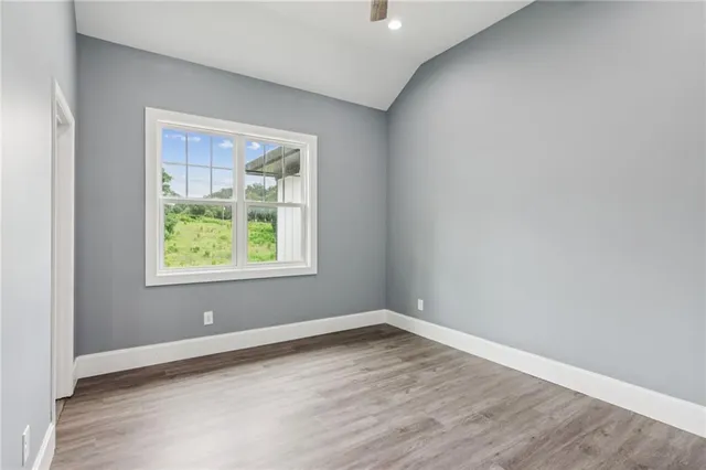 a view of house with a big yard and potted plants