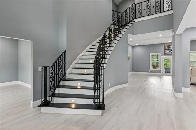 a view of entryway and hall with wooden floor