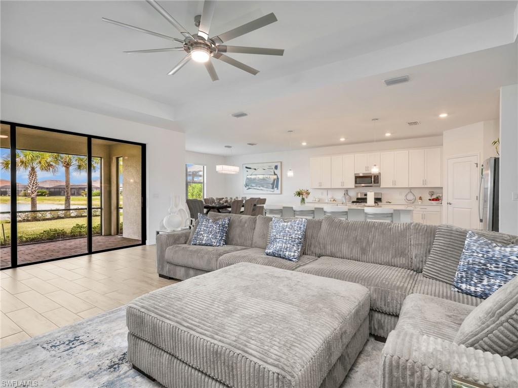 18278 Ridgeline Drive Estero, FL 33928 - Photo 15 of 45 a living room with furniture and a large window with kitchen view