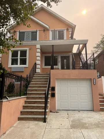 a front view of a house with a garden