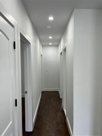 a view of hallway with wooden floor