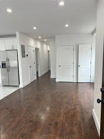 an empty room with cabinet and mirrors