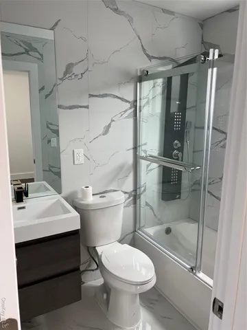 a bathroom with a sink toilet and shower
