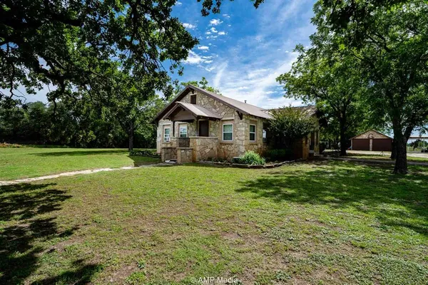 a front view of a house with yard and green space