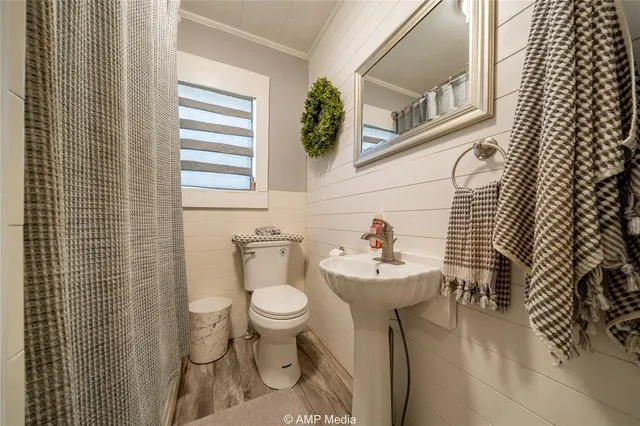 a bedroom with a bed dresser and a window