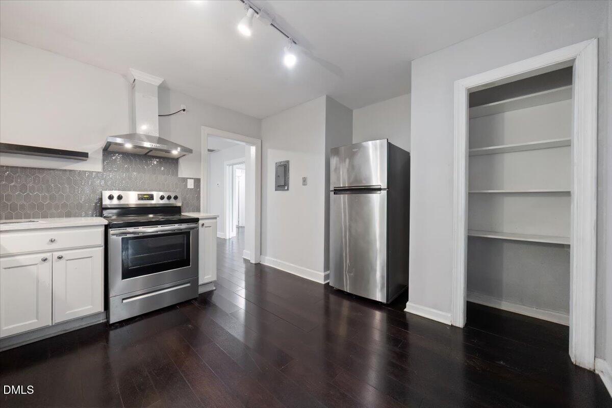 1213 Tarboro Street Southwest Wilson, NC 27893 - Photo 11 of 27 a kitchen with a refrigerator and a stove top oven