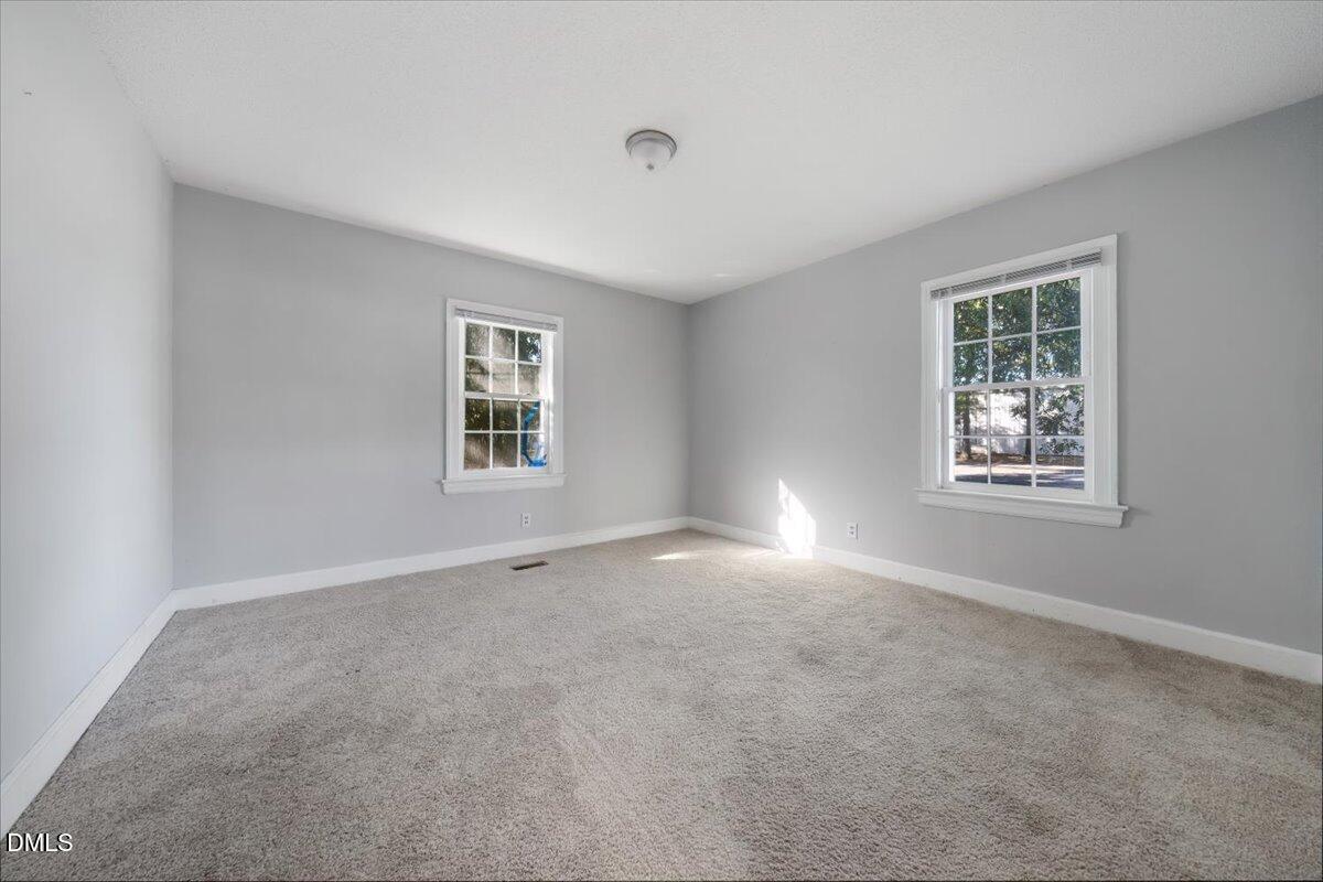 1213 Tarboro Street Southwest Wilson, NC 27893 - Photo 14 of 27 a view of an empty room with a window
