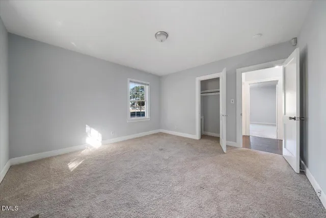 a bathroom with a toilet sink vanity and mirror