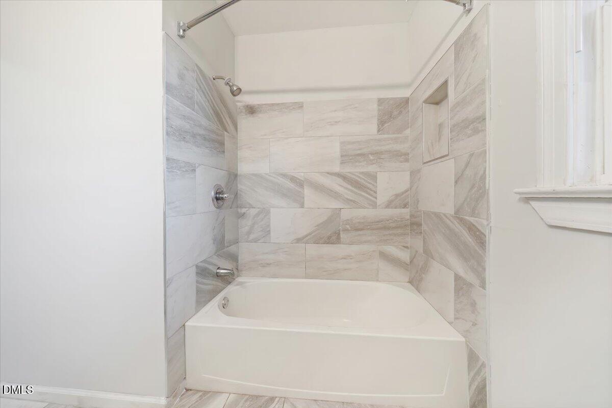 1213 Tarboro Street Southwest Wilson, NC 27893 - Photo 17 of 27 a bathroom with a bathtub