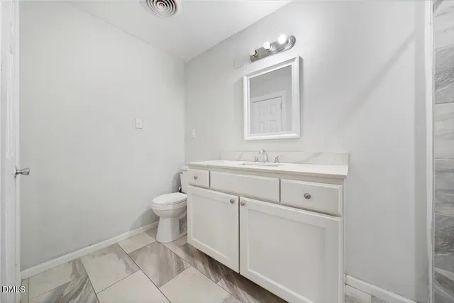 a bathroom with a shower sink and mirror
