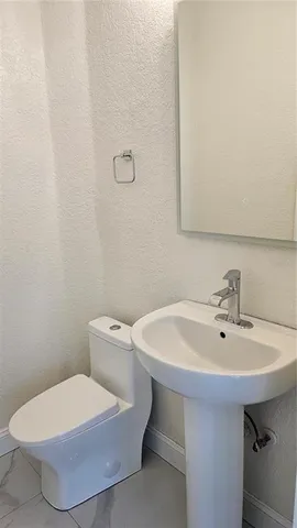 a view of a livingroom with a ceiling fan and wooden floor