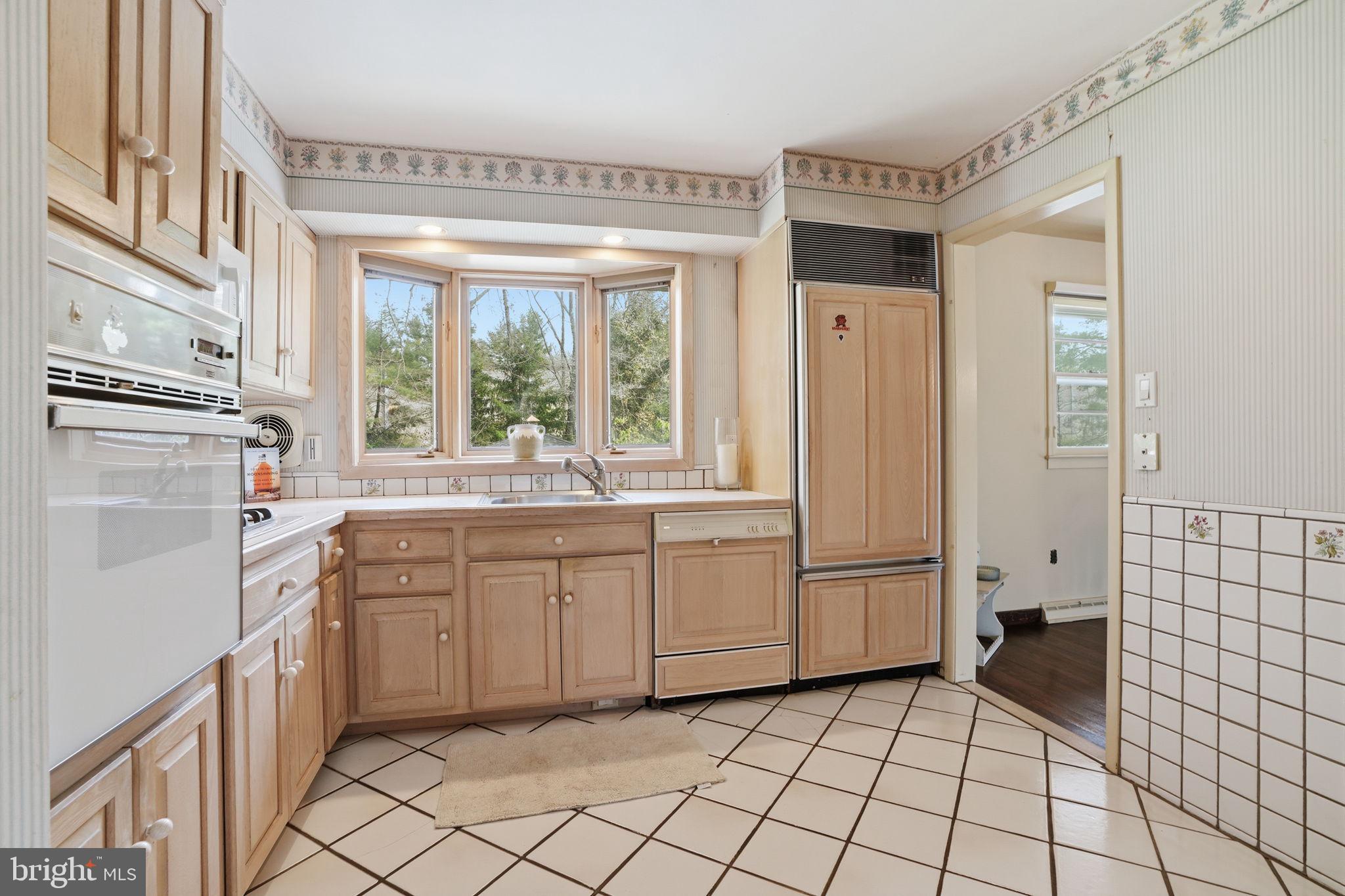 143 Pinehill Road Feasterville-Trevose, PA 19053 - Photo 3 of 43 a kitchen with white cabinets and white appliances