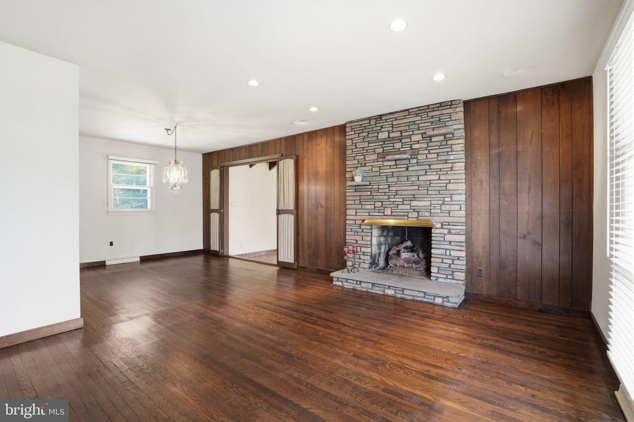 143 Pinehill Road Feasterville-Trevose, PA 19053 - Photo 9 of 43 an empty room with wooden floor fireplace and windows