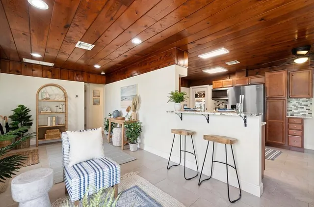 a living room with furniture and kitchen view