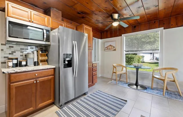 a kitchen with stainless steel appliances granite countertop a refrigerator and a stove top oven