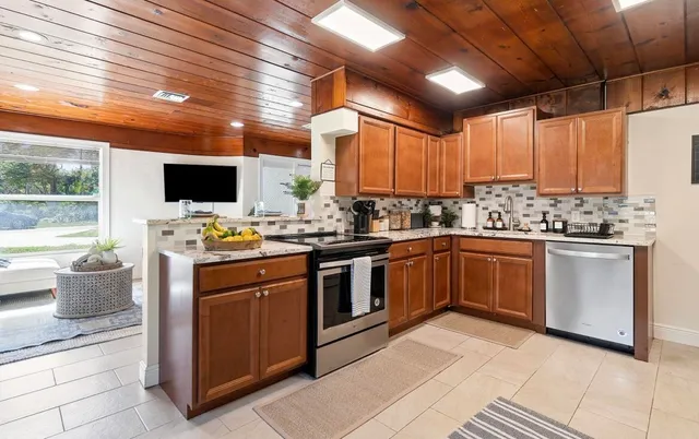 a kitchen with a stove sink and cabinets