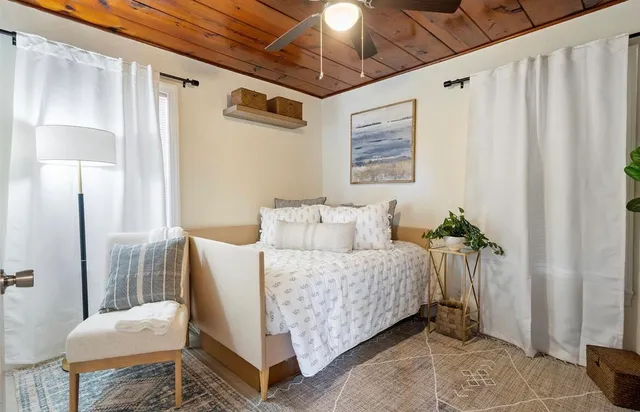 a bedroom with a bed and a mirror