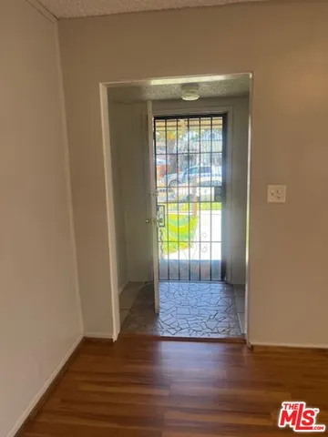 an empty room with wooden floor and a window