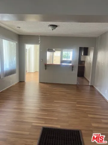 a view of a room with window and wooden floor