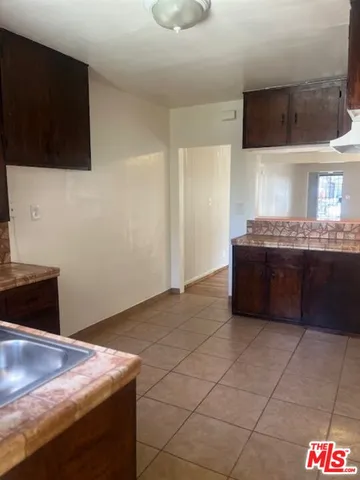 a kitchen with stainless steel appliances granite countertop a sink and a stove