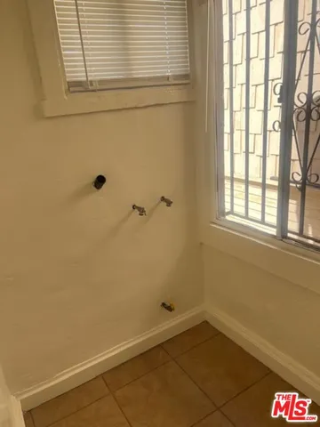a bathroom with a window and a shower