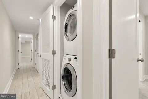 a view of a hallway with washer and dryer