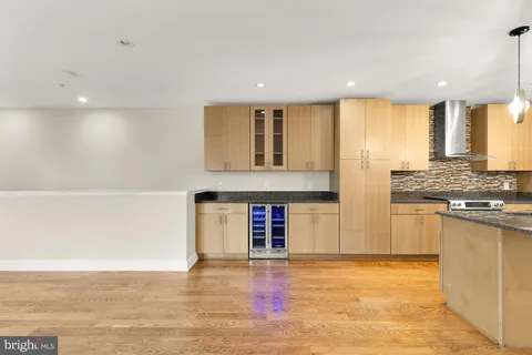 a view of open kitchen with granite countertop a stove top oven a sink and a counter top space