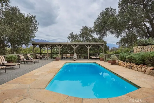 a view of swimming pool with sitting area