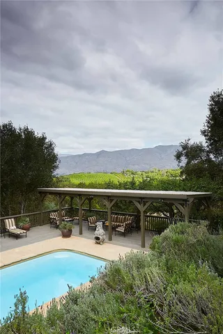 a view of a swimming pool with furniture