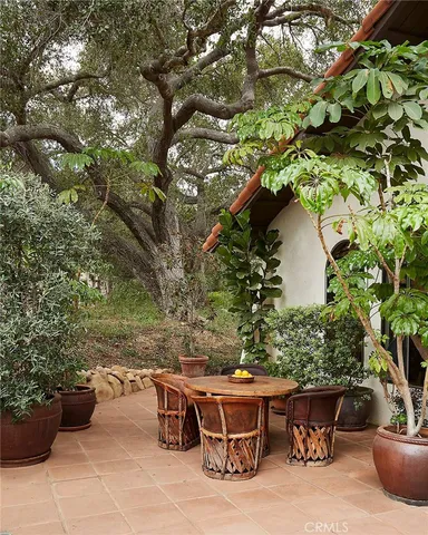 a backyard of a house with outdoor seating