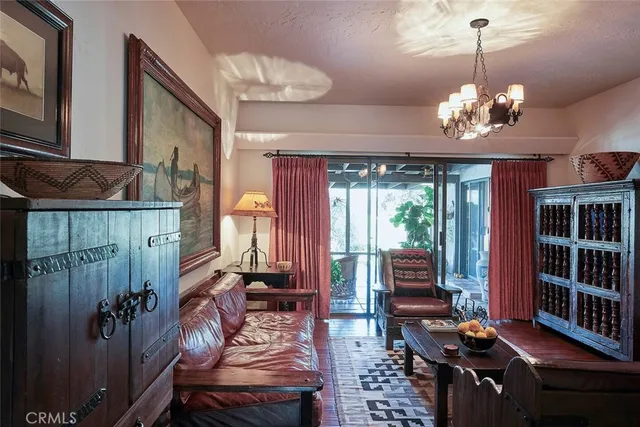 a view of a dining room with furniture wooden floor and chandelier