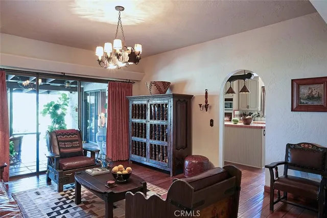 a living room with furniture a chandelier and a window
