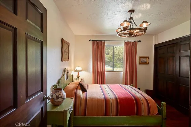 a bedroom with a bed and a chandelier