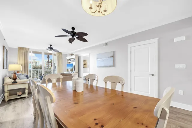 a living room with furniture ceiling fan and a wooden floor