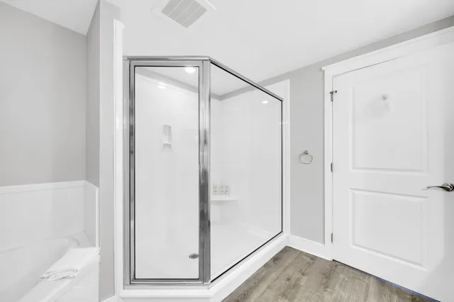 a bathroom with a shower and a sink