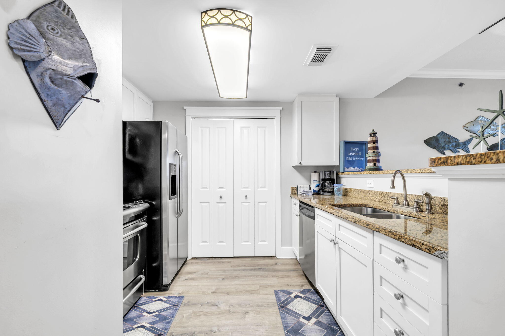 1110 Santa Rosa Boulevard, Unit A231 Fort Walton Beach, FL 32548 - Photo 3 of 59 a kitchen with a sink stainless steel appliances and cabinets
