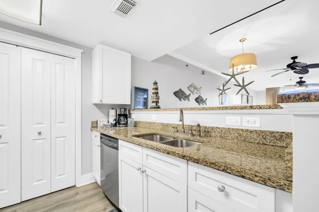 a kitchen with a sink and a granite counter tops