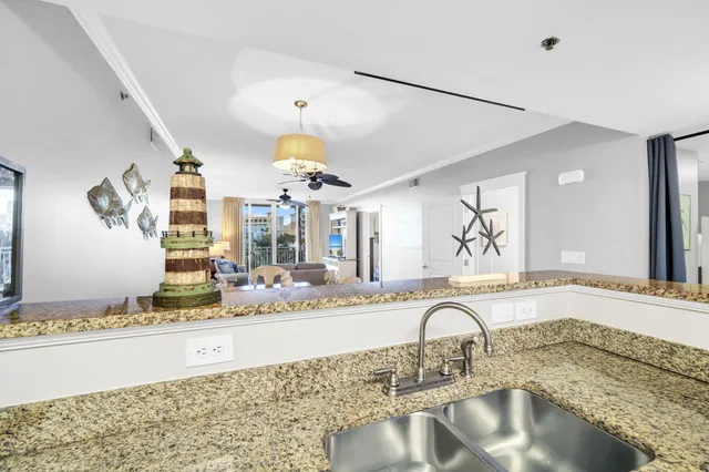 a kitchen with granite countertop a stove and a sink