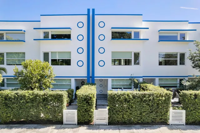 a front view of a multi story building with yard